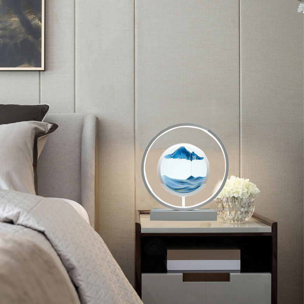 Decorative lamp on a nightstand next to a bed with a neutral wall background